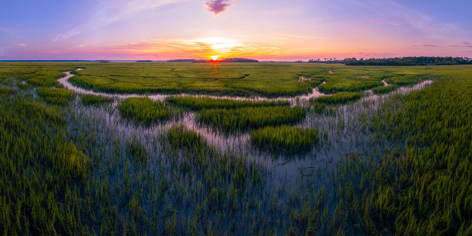 The sun sets over the salt marsh near the Broad River in Beaufort County, SC.